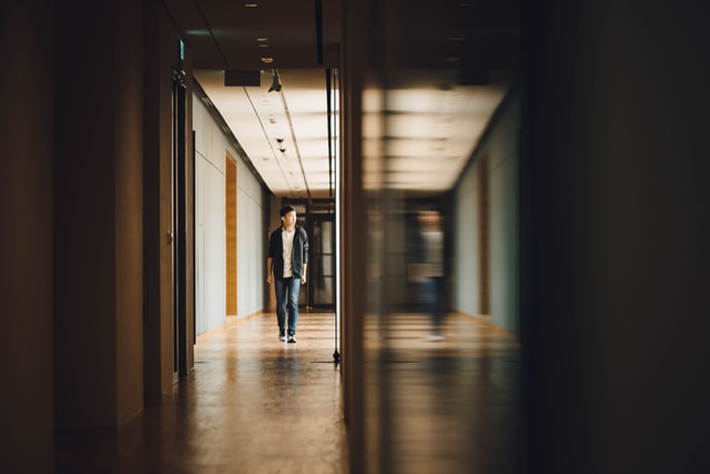 Student walking towards an open door