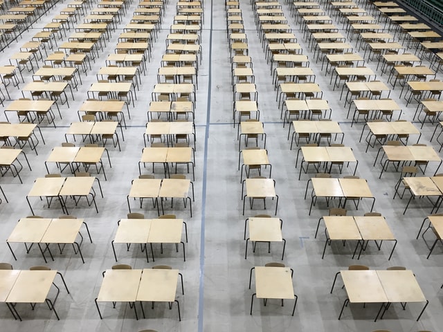 Exam hall desks empty.