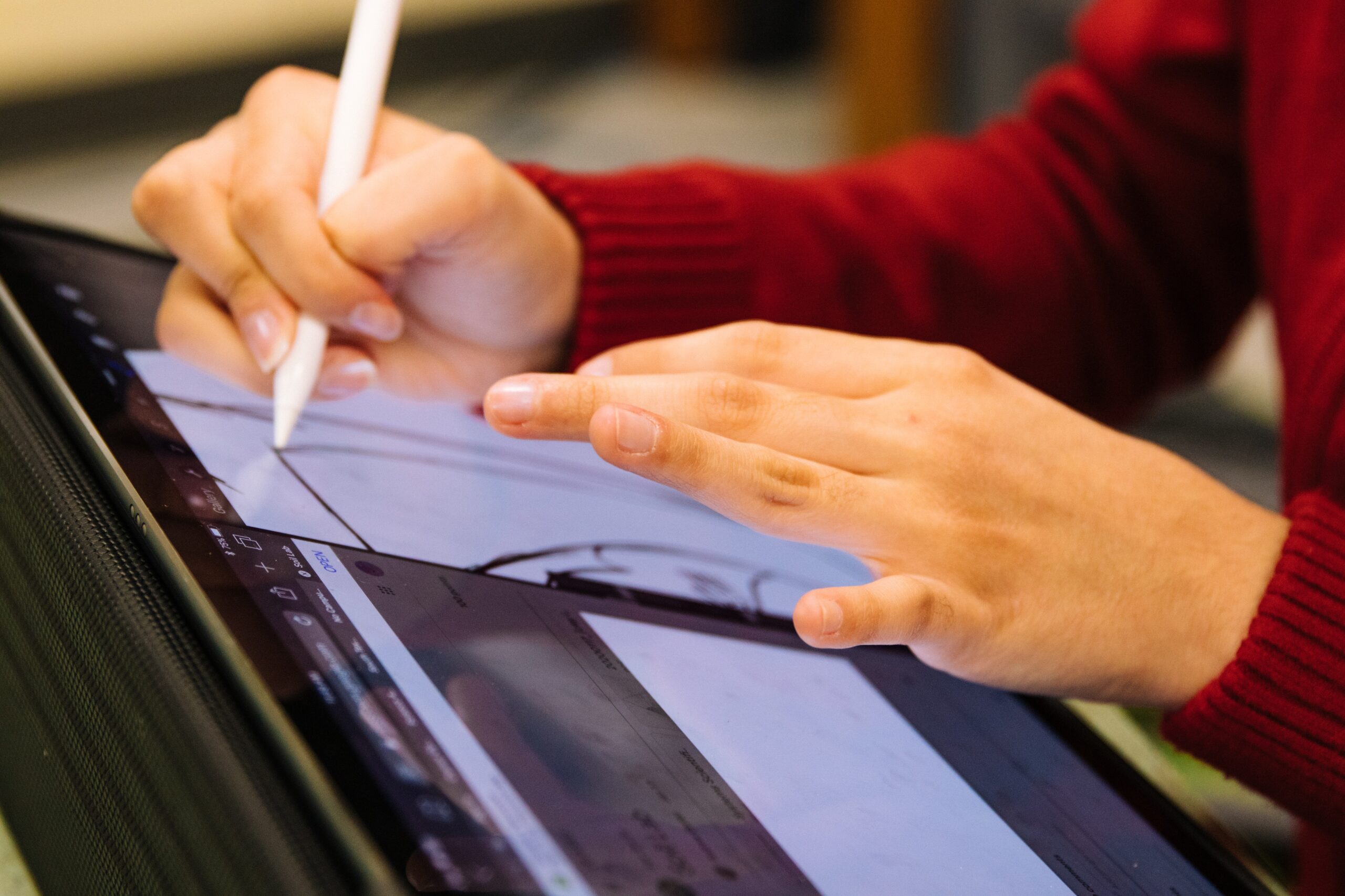 Person using tablet and pen.