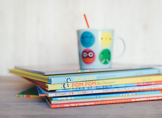 Mug balanced on a stack of books