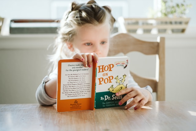 Young child reading at table