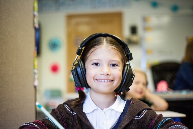Girl with headphones in classroom