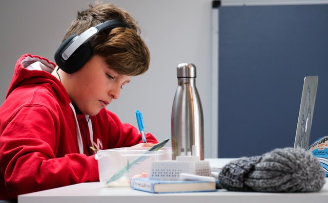 boy studying from home using laptop