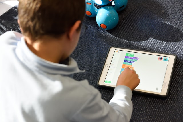 Boy using an educational app on a tablet.