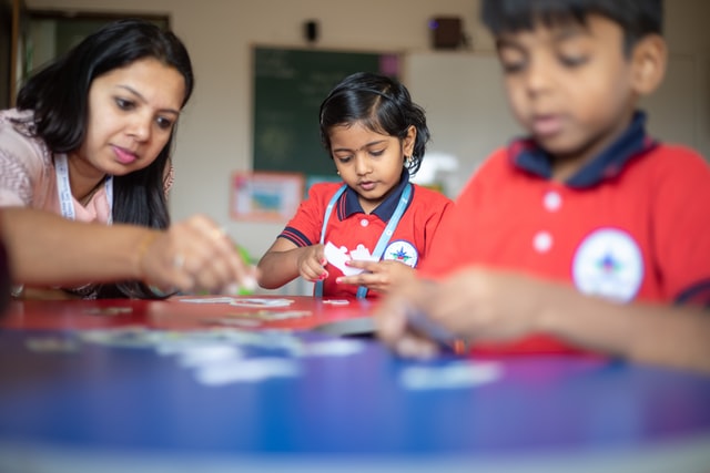 children playing a game with teacher