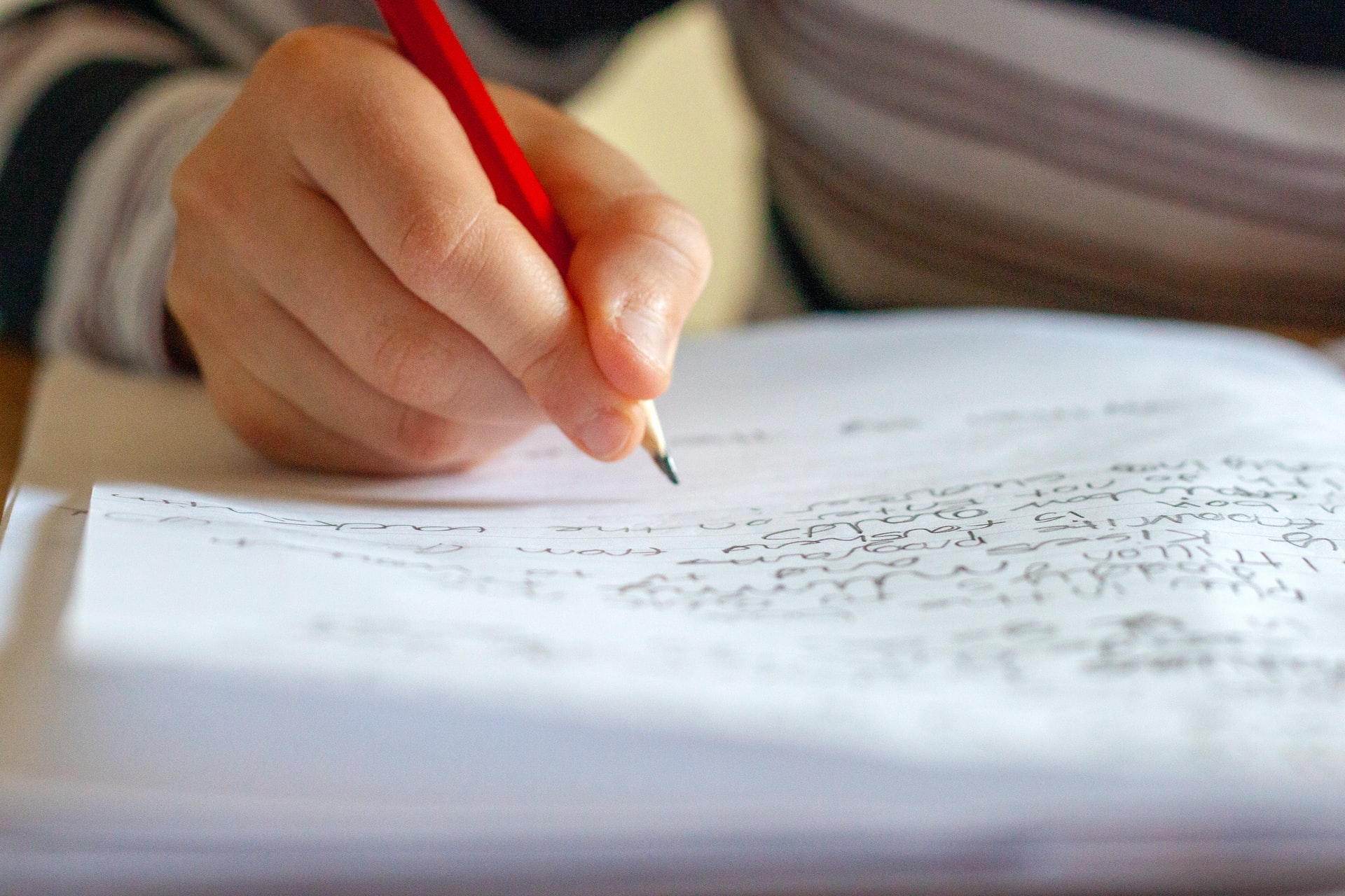 Child writing on a sheet of paper